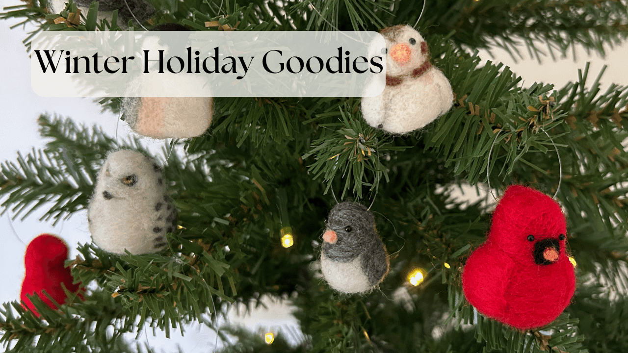 A close up of needle-felted ornaments in various North American bird species hanging from an artificial tree. The birds are small and round in borb style. Species include black-capped chickadee, snow bunting, snowy owl, Northern cardinal, and dark-eyed junco. Text in the upper right reads Winter Holiday Goodies.