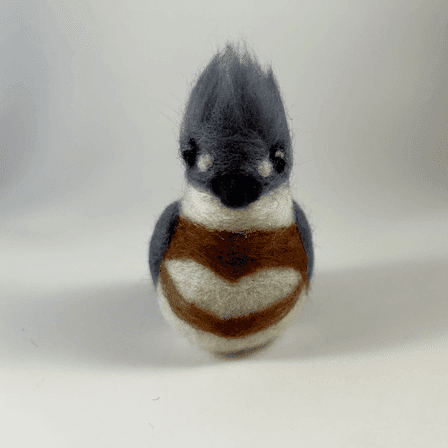 A needle-felted belted kingfisher borb faces directly towards the camera.