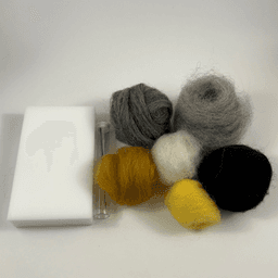 Laid out are small skeins of rolled up Charcoal fiber, Shadow fiber, Rust fiber, Sunshine fiber, Snowball fiber, and Black fiber. Also laid out is a foam block felting pad and a tube containing a felting needle.