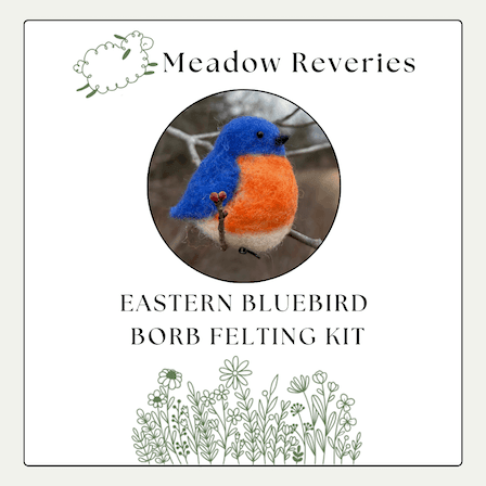 A needle felted Eastern bluebird is in a center circular inset. Above, the brand name Meadow Reveries with a cartoon leaping sheep. Below, EASTERN BLUEBIRD FELTING KIT. At the bottom, decorative cartoon wildflowers.