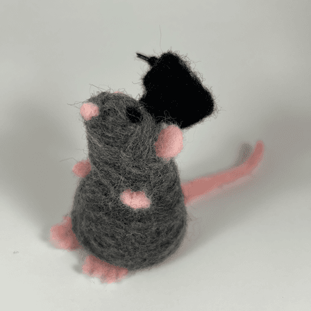 A grey rat with black eyes, pink nose, pink ears, pink paws and pink tail wearing a black graduation cap faces 1/4 left forward. It's in standing pose flat on its hind paws.