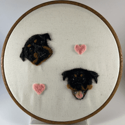 Wool portrait on rottweilers Vanya and Sheba in an 8 inch embroidery frame.