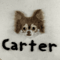 Close up of a needle-felted portrait of a brown and tan chihuahua with his name written below, Carter.