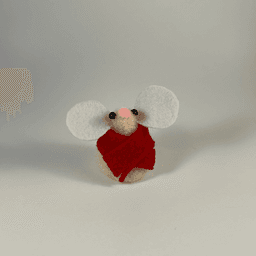 A needle-felted cream colored mouse wearing a red scarf facing towards the camera.