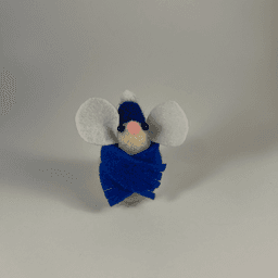 A needle-felted cream colored mouse wearing a blue scarf and blue hat facing towards the camera.