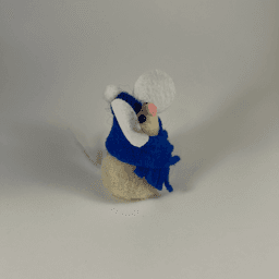 A needle-felted cream colored mouse wearing a blue scarf and blue hat facing towards the right.