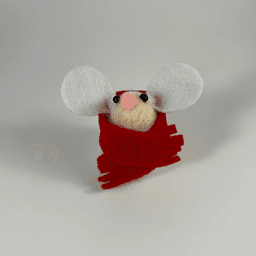 A needle-felted cream colored mouse wearing a red scarf facing towards the camera.