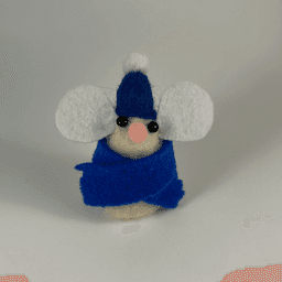 A needle-felted cream colored mouse wearing a blue scarf and blue hat facing towards the camera.